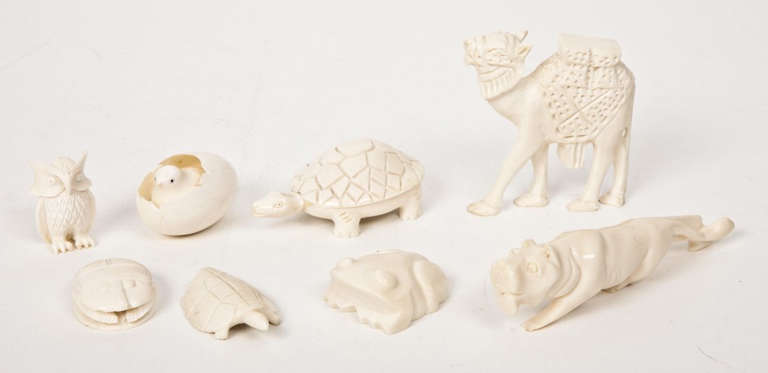 A Collection of Eight Carved Ivory Animals Height: A Collection of Eight Carved Ivory Animals comprising a camel, two turtles, a panther, a newborn bird, an owl, a scarab and a frog. Height of tallest 3 1/4 inches.