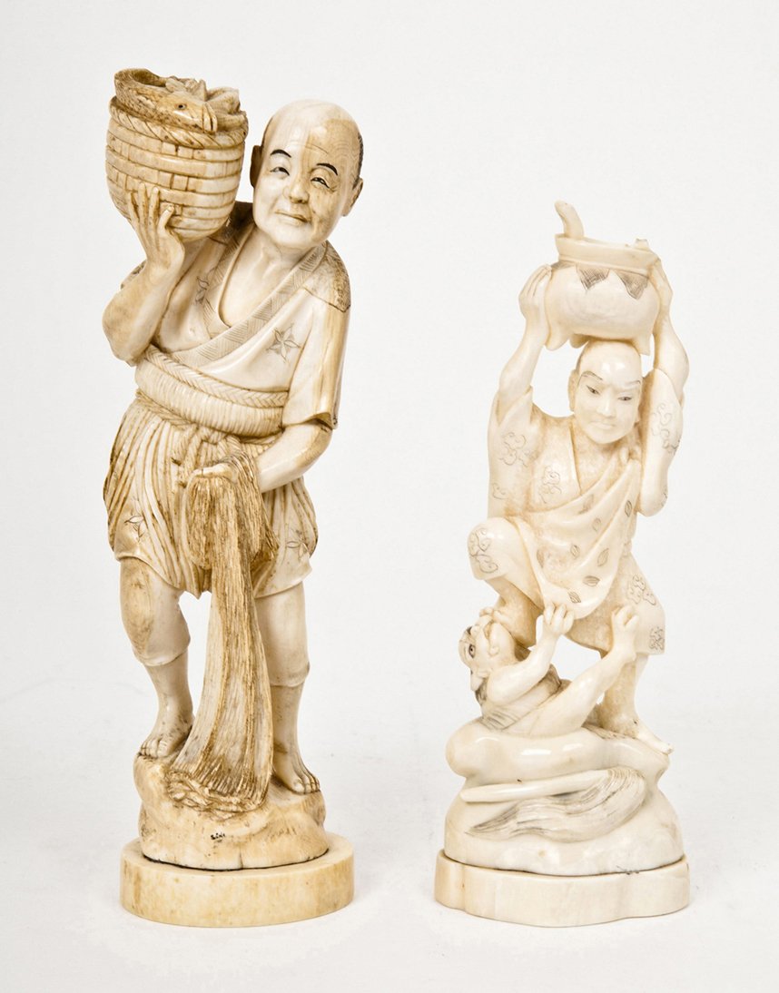 Two Japanese Okimono, Height of taller 7 1/2 inche: Two Japanese Okimono, the first of a fisherman carrying a wicker basket holding fish, the second holding a basket over his head while fending off a cat. Height of taller 7 1/2 inches.