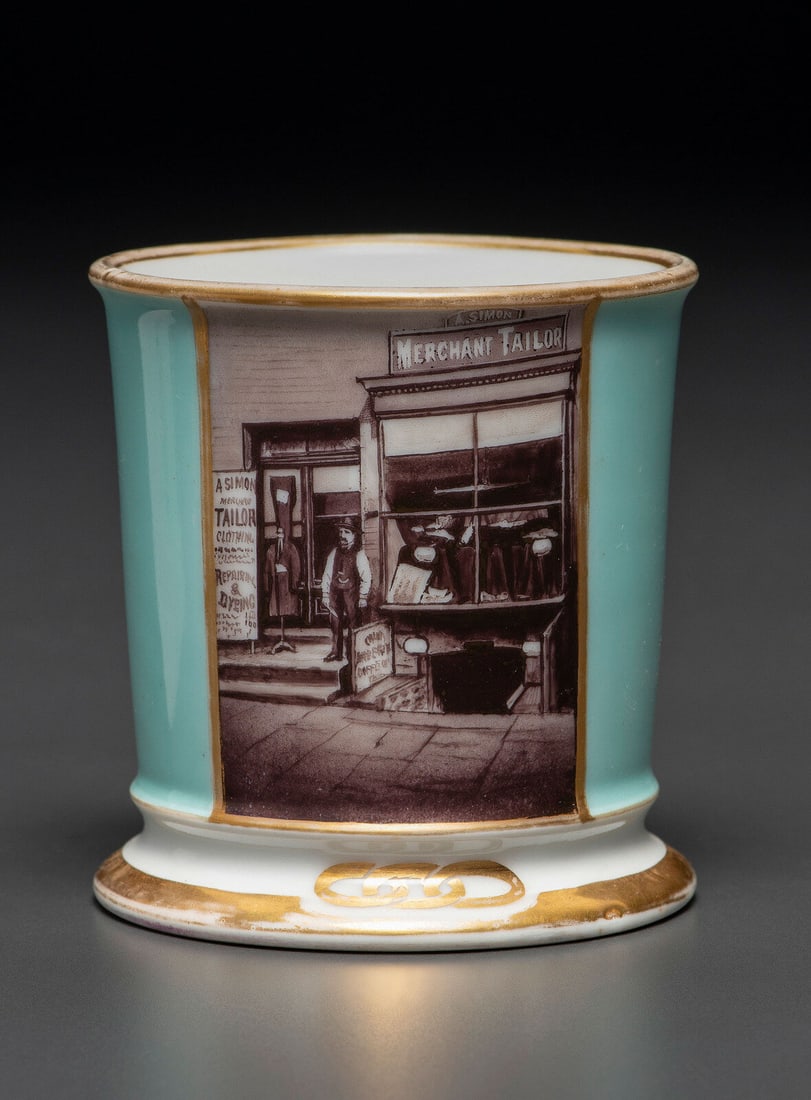 A Paint Enhanced Photographic Transfer Porcelain Occupational Shaving Mug Depicting a Tailor's Shop (1 of 4)