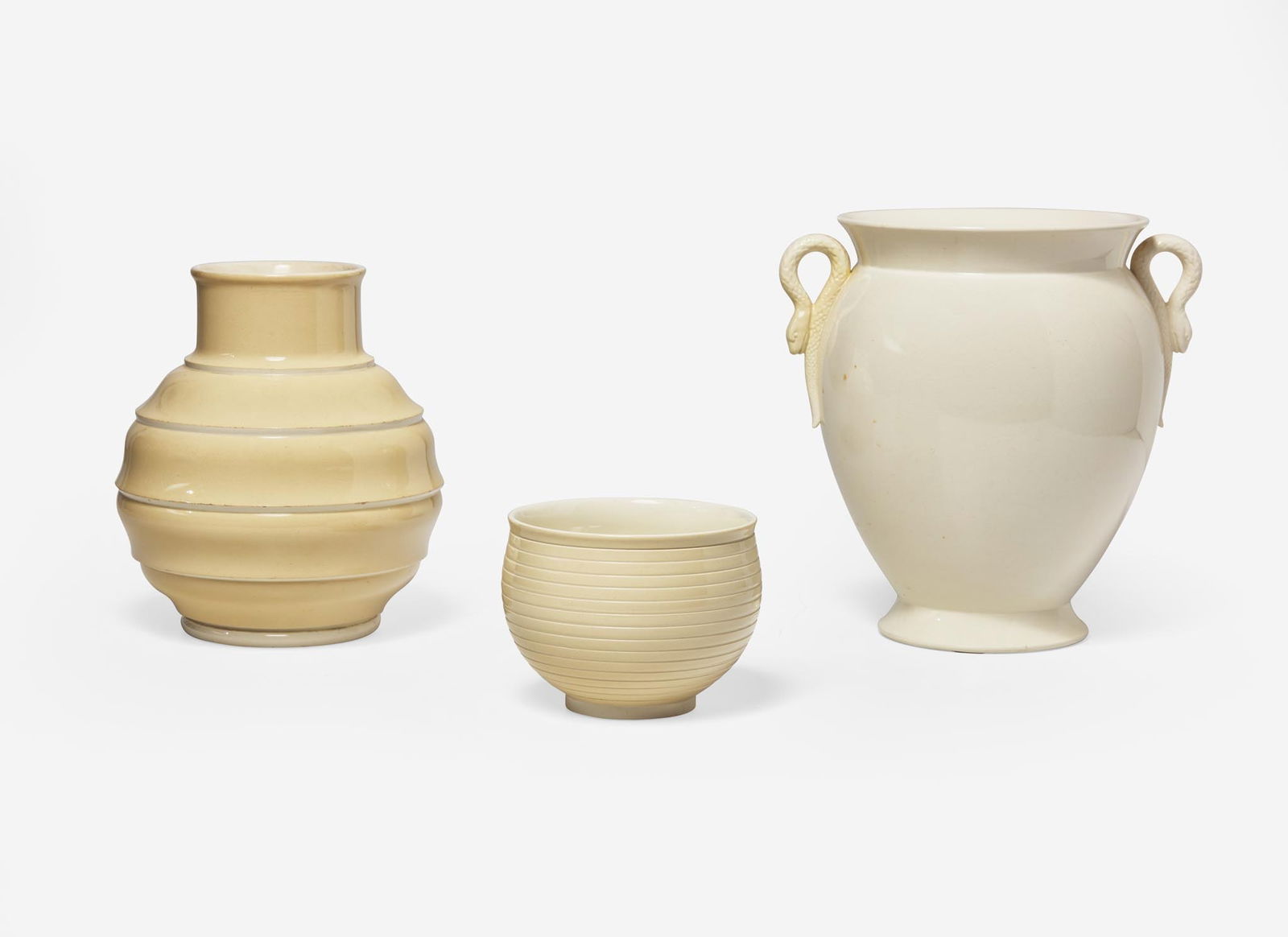Three Wedgwood Keith Murray Designed Vessels, UK, 1930s: Three Wedgwood Keith Murray Designed Vessels, UK, 1930s Glazed earthenware All three in Queensware, comprising a large vase with snake form handles, a spherical vase in a glossy cream-colored glaze an