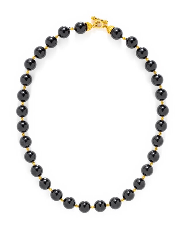 HIGH KARAT YELLOW GOLD AND ONYX BEAD NECKLACE: HIGH KARAT YELLOW GOLD AND ONYX BEAD NECKLACE Onyx beads measuring approximately 12.50 mm, with high karat yellow gold clasp. 22 karat yellow gold. 20 inches long. Stamp: 22K. Gross weight: 59.30 dwt.