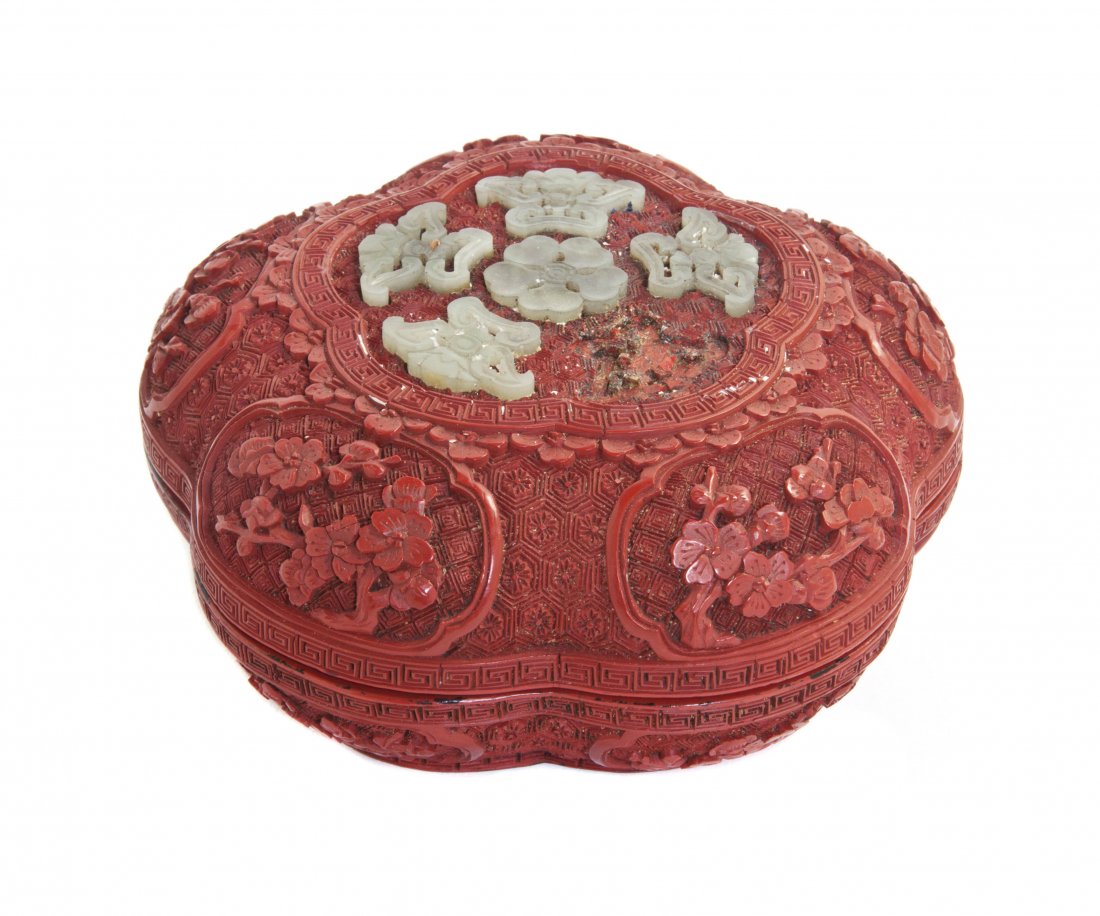 A Chinese Five-Lobed Carved Cinnabar Lacquer Box a: A Chinese Five-Lobed Carved Cinnabar Lacquer Box and Cover, 18th century, the top inset with carved jade floriform medallions within a key-fret border, the lid and base both containing five shaped car