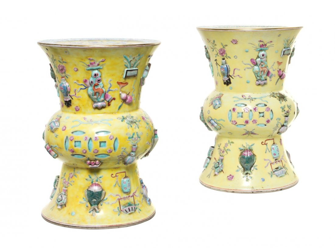 A Pair of Chinese Porcelain Garden Seats, Height 1: A Pair of Chinese Porcelain Garden Seats, each having a circular seat over the waisted support, with molded decoration throughout depicting traditional vessels, coins and auspicious motifs on a yellow