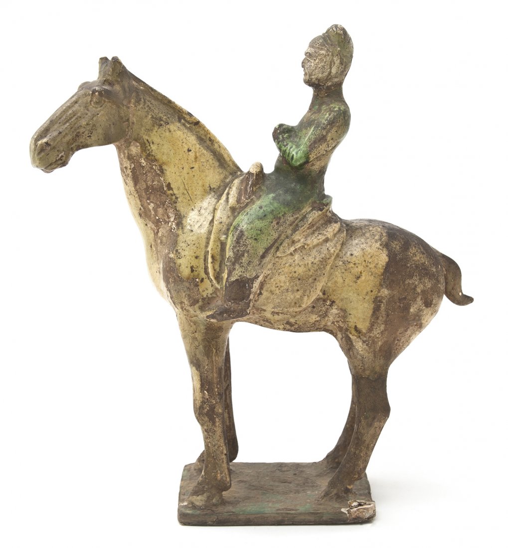 A Chinese Pottery Model of a Horse and Rider, Heig: A Chinese Pottery Model of a Horse and Rider, Tang Dynasty style, depicting a figure in a green robe atop a forward facing straw glazed horse raised upon a rectangular plinth base. Height 13 1/2 inche