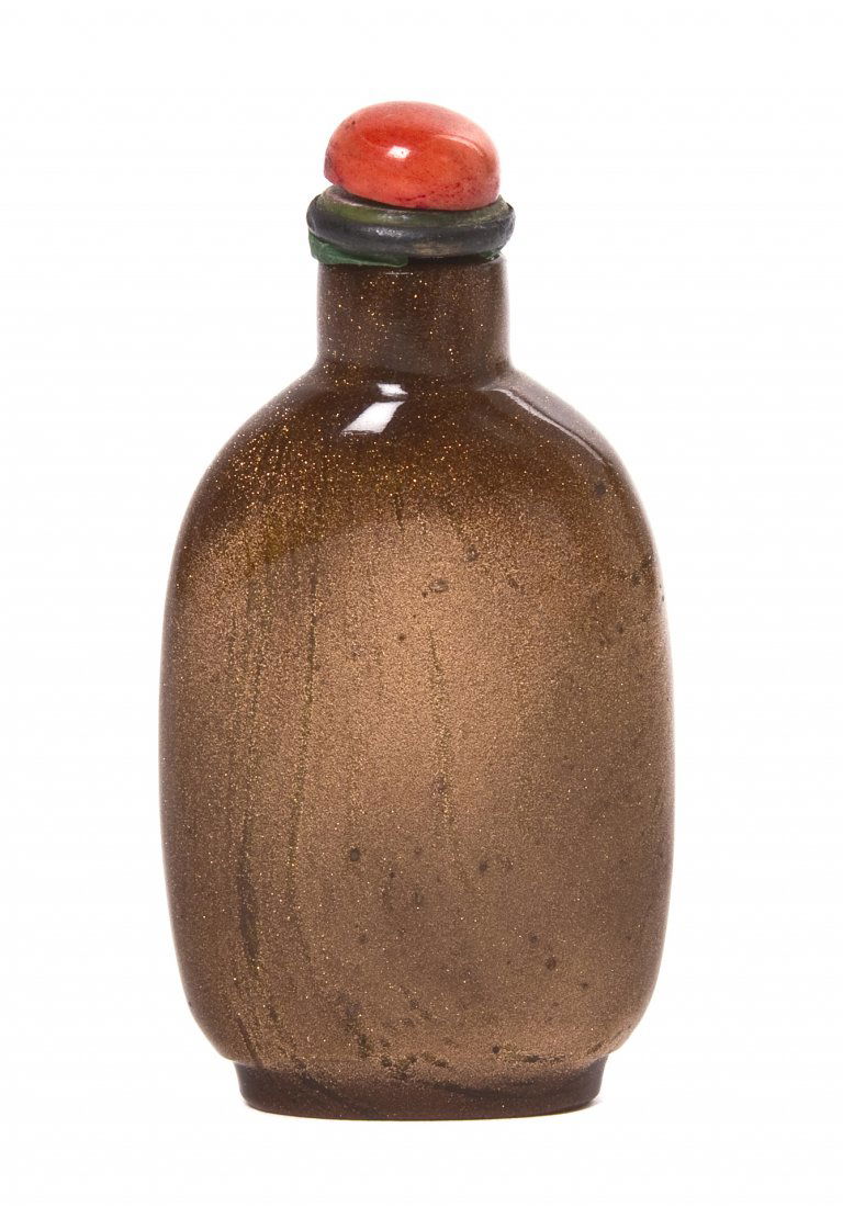 A Copper Glass Snuff Bottle, Height 2 3/8 inches.: A Copper Glass Snuff Bottle, with metallic fleck finish and having a red coral stopper. Height 2 3/8 inches. Property from the Collection of Jean F. Schmidt, Chicago, Illinois