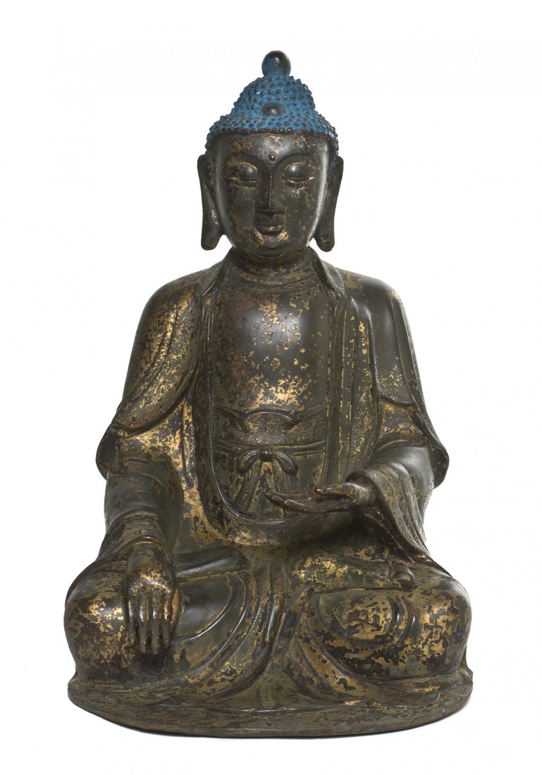 A Chinese Bronze Model of Buddha, Height 15 1/4 in: A Chinese Bronze Model of Buddha, depicted in a seated pose, having small snail knots throughout his hair with blue pigment, having one hand raised above his lap and the other draped over his leg, wit