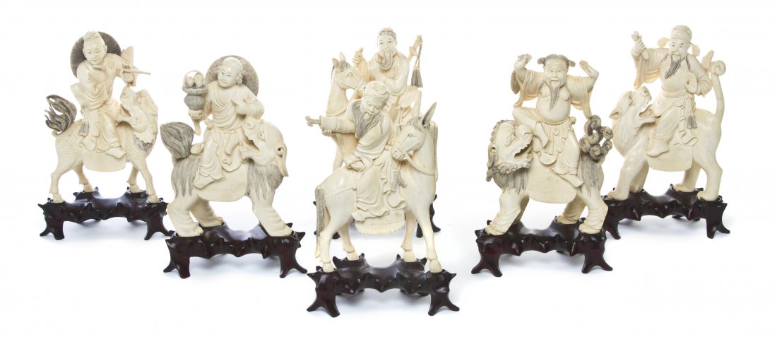 A Set of Six Chinese Carved Ivory Immortals, Heigh: A Set of Six Chinese Carved Ivory Immortals, the figures depicted riding qilin, a donkey, a horse and lions, each posed with their traditional attributes and raised atop a fitted hardwood stand. Heigh