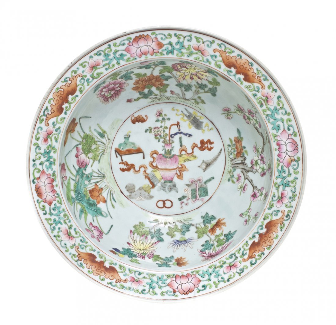 A Chinese Famille Rose Decorated Porcelain Center : A Chinese Famille Rose Decorated Porcelain Center Bowl, the wide rimmed bowl having decoration on the rim of scrolling lotus plants and iron red bats, the interior with various flowering plants, with 