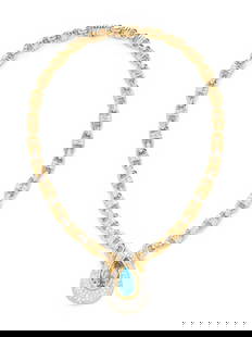 BICOLOR GOLD, BLUE TOPAZ AND DIAMOND NECKLACE: BICOLOR GOLD, BLUE TOPAZ AND DIAMOND NECKLACE Pear shaped blue topaz measuring approximately 19.30 x 12.15 x 9.00 mm and round brilliant cut diamonds weighing approximately 2.90 carats total. 16