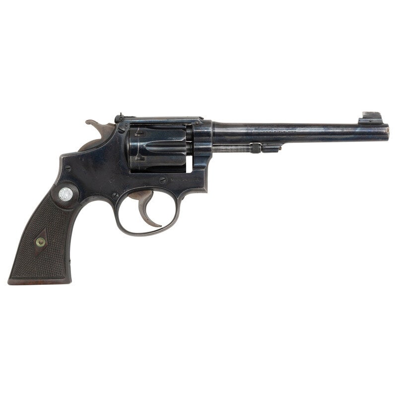 **Smith & Wesson K-22 Outdoorsman: **Smith & Wesson K-22 Outdoorsman .22 LR. 6" barrel length. SN: 644603. Blued metal finish with casehardened hammer and trigger mounting diamond checkered walnut Smith & Wesson medallion grips
