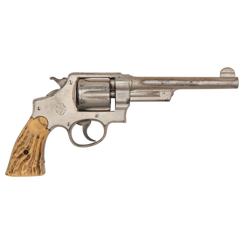 **Smith & Wesson .44 Hand Ejector First Model Triple Lock: **Smith & Wesson .44 Hand Ejector First Model Triple Lock .44 Special. 6.5" barrel length. SN: 13661. Nickel plated finish with casehardened hammer and trigger mounting bone grips. Double action h