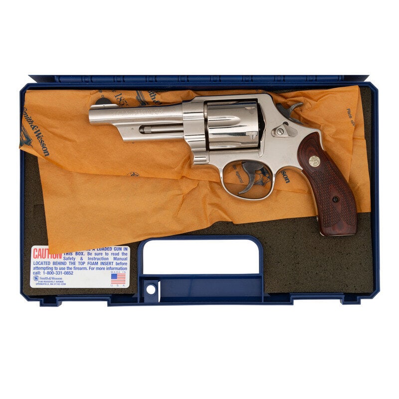*Smith & Wesson Model 21-4 in Box with Accessories: *Smith & Wesson Model 21-4 in Box with Accessories .44 Special. 4" barrel length. SN: CJL1219. Nickel plated finish overall with casehardened hammer and trigger, and mounting laminated wood Smith