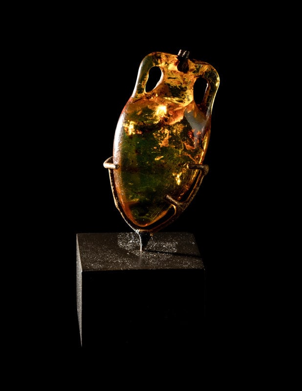 A Roman Natural Amber Amphoriskos Pendant: A Roman Natural Amber Amphoriskos Pendant Circa 1st-3rd Century A.D. 1 1/8 x 5/8 inches. This lot is located in Chicago. Provenance Provenance: Fortuna Fi