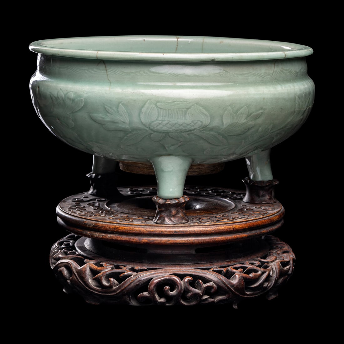 A Chinese Longquan Celadon Glazed Porcelain Tripod Censer: A Chinese Longquan Celadon Glazed Porcelain Tripod CenserMing Dynasty (1368-1644)明 龍泉窯青釉刻划花三足大香爐having