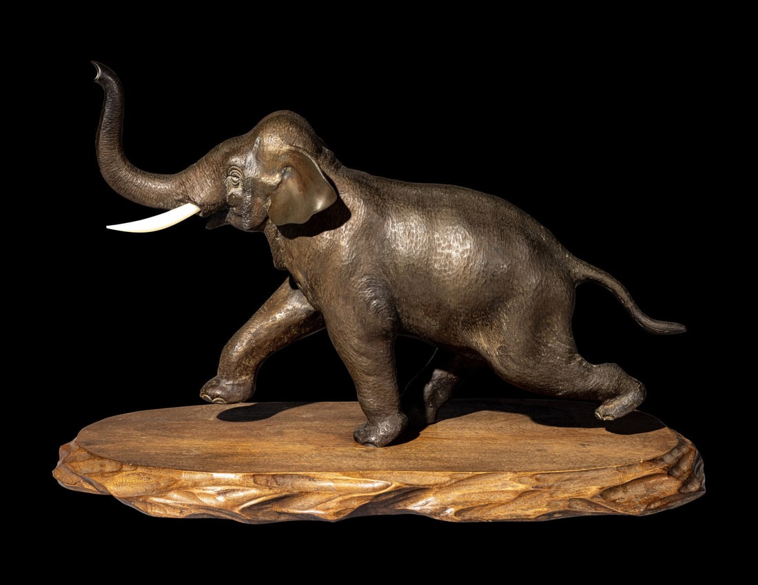 A Japanese Bronze Okimono of an Elephant: A Japanese Bronze Okimono of an Elephant Early 20th Century the animal cast in an elongated stride, the underside of the leading forefoot incised Tsunemitsu , 常光. Length 14 1/2 x height 