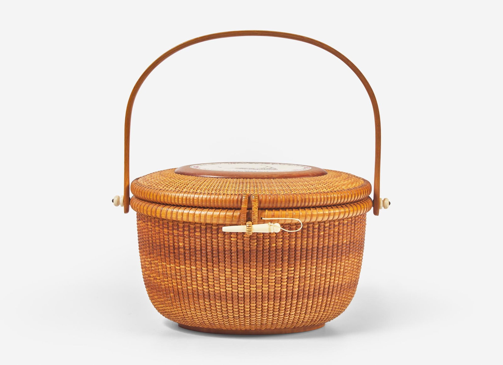 A Nantucket basket, Alan S. W. Reed, with scrimshaw plaque by Lee Anne Papale, dated "1989": A Nantucket basket, Alan S. W. Reed, with scrimshaw plaque by Lee Anne Papale, dated "1989" The scrimshaw plaque to lid engraved with flowers, signed and dated, “Lee A. Papale 89,” the und