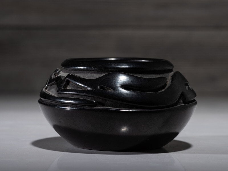Teresita Naranjo (Santa Clara, 1919-1999) Blackware Pottery Jar: Teresita Naranjo (Santa Clara, 1919-1999) Blackware Pottery Jar deeply carved with Avanyu around shoulder; signed on base height 3 inches x diameter 5-1/2 inches This lot is located in Cincinnat