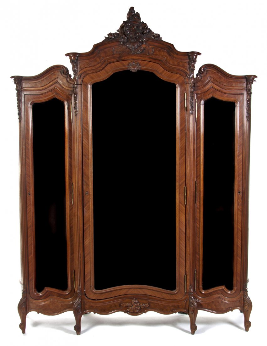 A Louis XV Style Kingwood Armoire, Height 104 1/2 : A Louis XV Style Kingwood Armoire, in three sections, the center with a carved foliate crest and a molded cornice above a beveled mirror inset door opening to shelves, each side section having a glass