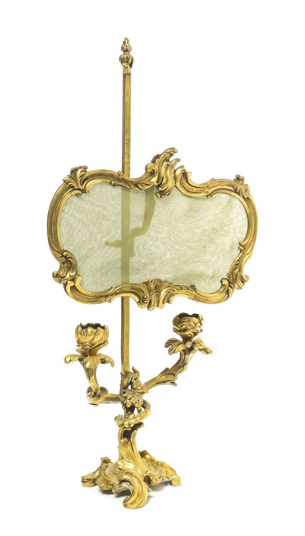 A Louis XV Style Gilt Bronze Bouillotte Lamp, Paul: A Louis XV Style Gilt Bronze Bouillotte Lamp, Paul Sormani (1817-1877), having a foliate cast screen inset with silk on a telescoping standard issuing floriform candle arms, cups and bobeches, raised