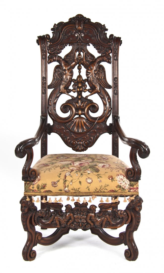 A Renaissance Revival Carved Hall Chair, Height 56: A Renaissance Revival Carved Hall Chair, having a foliate crest over the pierce carved back formed by two opposing phoenixes, the upholstered seat enclosed by open arms with scrolled terminals, raised