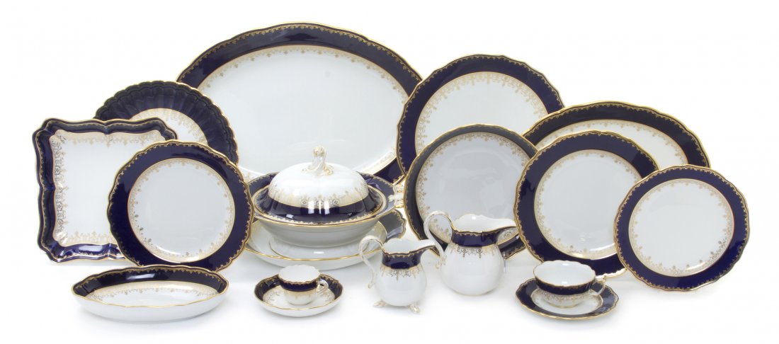 A Meissen Porcelain Dinner Service, Diameter of di: A Meissen Porcelain Dinner Service, having cobalt and gilt decorated borders, comprising 12 dinner plates, 12 luncheon plates, 12 salad plates, 11 bread plates, 5 coffee cups, 7 teacups, 6 demitasse c