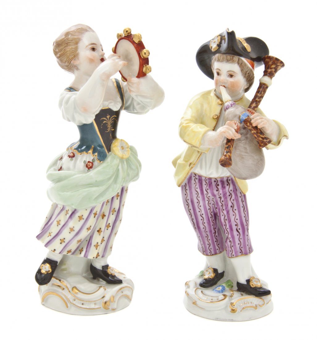 A Pair of Meissen Porcelain Figures of Youthful Mu: A Pair of Meissen Porcelain Figures of Youthful Musicians, one depicting a girl with a tambourine, the other a boy with a bagpipe, having crossed swords mark in underglaze blue with various incised an