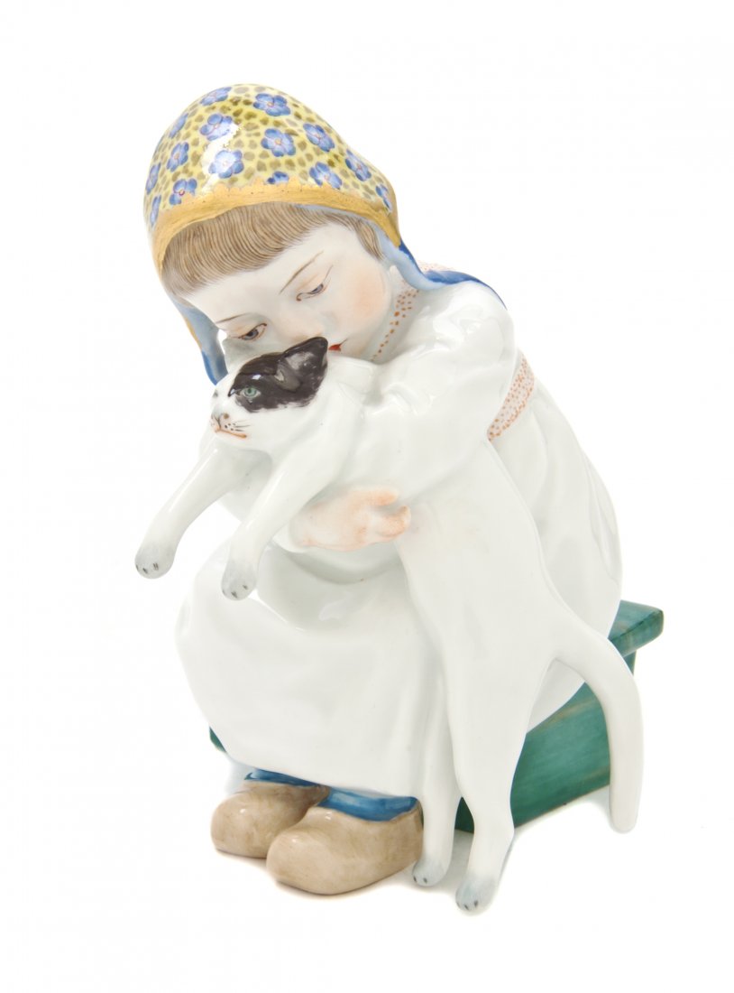 A Meissen Porcelain Figure, Konrad Hentschel (1872: A Meissen Porcelain Figure, Konrad Hentschel (1872-1907), depicting a girl with a cat, impressed 121 with other incised marks, having crossed swords in underglaze blue. Height 5 inches. Property from