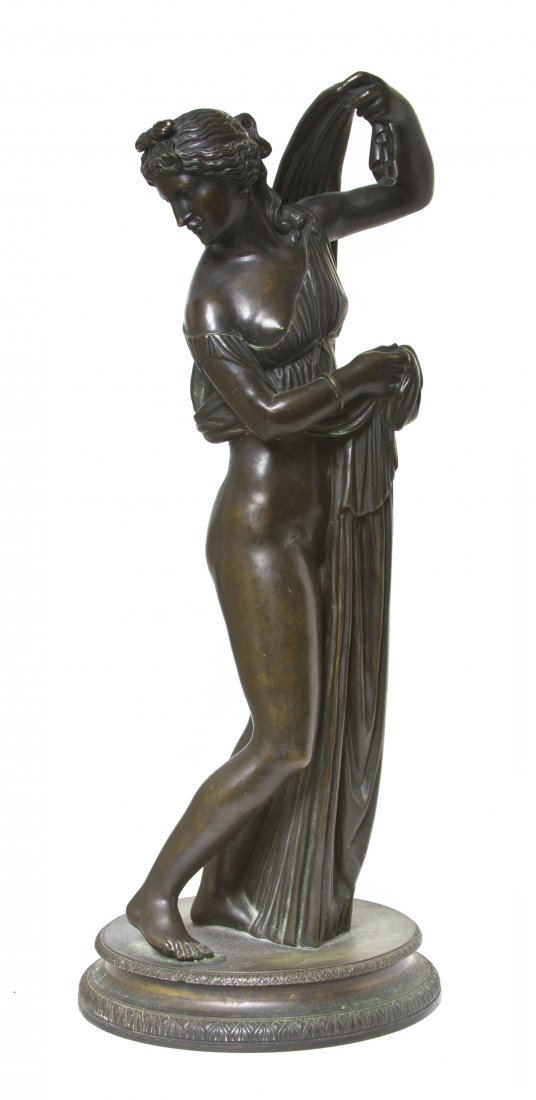 A Continental Bronze Figure, after the Antique, He: A Continental Bronze Figure, after the Antique, depicting Venus Callipyge, also known in Greek as Aphrodite Kallipygos, raised on a circular plinth base. Height 23 1/4 inches.