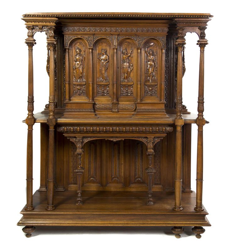 A Renaissance Revival Carved Walnut Buffet a Deux: A Renaissance Revival Carved Walnut Buffet a Deux Corps, in two parts, the superstructure with an egg-and-dart cornice and panel doors depicting Greco-Roman figures in relief, the base with turned sup