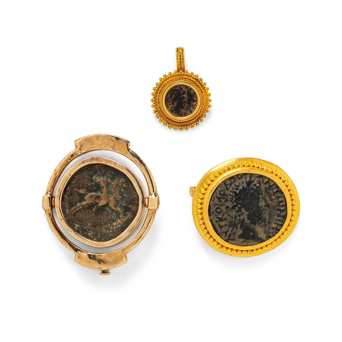 COLLECTION OF YELLOW GOLD AND COIN MOTIF JEWELRY: COLLECTION OF YELLOW GOLD AND COIN MOTIF JEWELRY Including two brooches and one pendant. Yellow gold. Pendant: 1 inch long. Brooches: 1 5/8 x 1 3/8 inches and 1 5/16 x 1 1/4 inches. Large Brooch Stamp