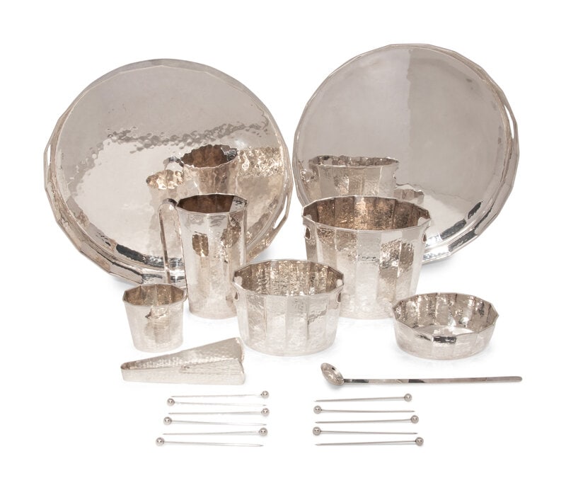 A Set of Italian Hand Hammered Silver-Plate Table Articles: A Set of Italian Hand Hammered Silver-Plate Table Articles Cassetti, Florence, Second Half 20th Century comprising a pair of silver trays, two ice buckets (of varying size), tongs, a pitcher, a small