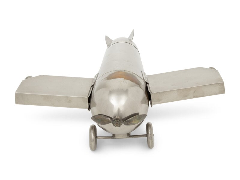 A German Chromed-Metal Airplane-Form Cocktail Shaker, Flask and Mixing Set: A German Chromed-Metal Airplane-Form Cocktail Shaker, Flask and Mixing Set Second Half 20th Century the fuselage cocktail shaker having detachable flasks for wings, the tail unscrewing to reveal three