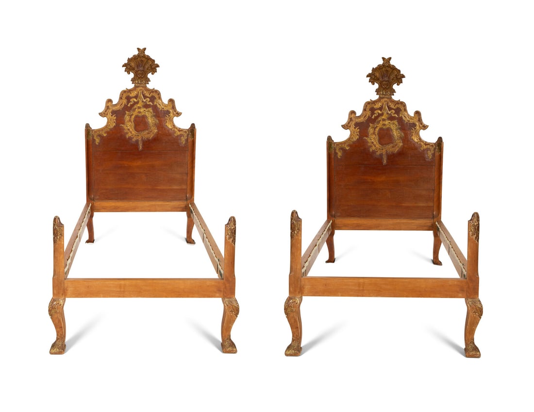 A Pair of Venetian Style Fruitwood and Parcel Gilt Twin Beds: A Pair of Venetian Style Fruitwood and Parcel Gilt Twin Beds 19th Century and Later Height 68 x width 40 x length 82 inches overall. Property from the Collection of William L. Bernhard and Catherine C