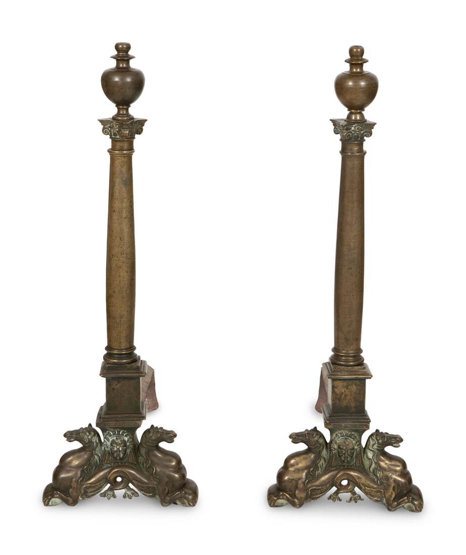 A Pair of Large Patinated Metal Andirons: A Pair of Large Patinated Metal Andirons 19th Century and Later With hippocampus-form bases, bases and columns possible associated Height 45 1/2 x width 15 x depth 32 inches. Property from the Estate