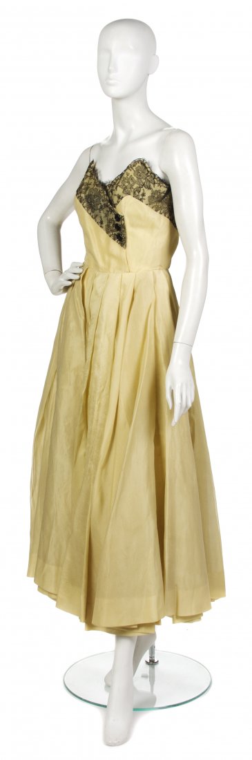A Jacques Fath Yellow Organza and Black Chantilly L: A Jacques Fath Yellow Organza and Black Chantilly Lace Strapless Gown, mid 1950s, with matching stole. Labeled: Jacques Fath / Designs for Joseph Halpert. Property from a New York City Collection