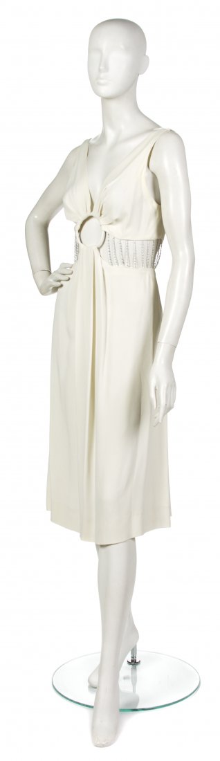 A Karl Lagerfeld Cream Silk and Chain Cocktail Dre: A Karl Lagerfeld Cream Silk and Chain Cocktail Dress, circa 1970s, 'V' neckline and open stomach with delicate silver chains holding together bodice and skirt. Labeled: Karl Lagerfeld. Size 42.
