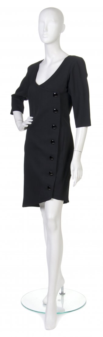 An Yves Saint Laurent Black Wool Cocktail Dress, S: An Yves Saint Laurent Black Wool Cocktail Dress, a scoop neckline and faceted black buttons down one side. Labeled: Yves Saint Laurent. Size 38. Property from the Collection of Susan Garrett, Chicago,