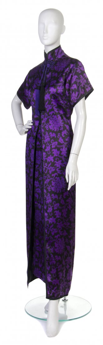An Yves Saint Laurent Black and Purple Silk Orient: An Yves Saint Laurent Black and Purple Silk Oriental Ensemble, late 1970s, in a modified cheongsam design with stylized allover scrolling floral motif, passementerie and tassel closure, black dome but