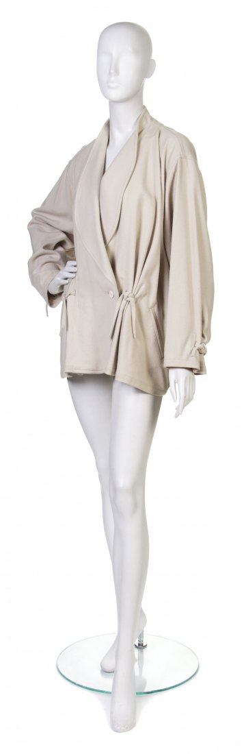 An Issey Miyake Cream Wool Jacket,: An Issey Miyake Cream Wool Jacket, knot details at cuffs, back waist, and hips. Labeled: Issey Miyake. Property from a Private Collection, Winnetka, Illinois