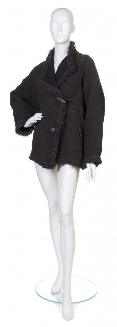 An Issey Miyake Black Jacket, Size S.: An Issey Miyake Black Jacket, fringe trim, braided self belt, detachable wool inner lining. Labeled: Issey Miyake. Size S. Property from a Private Collection, Winnetka, Illinois