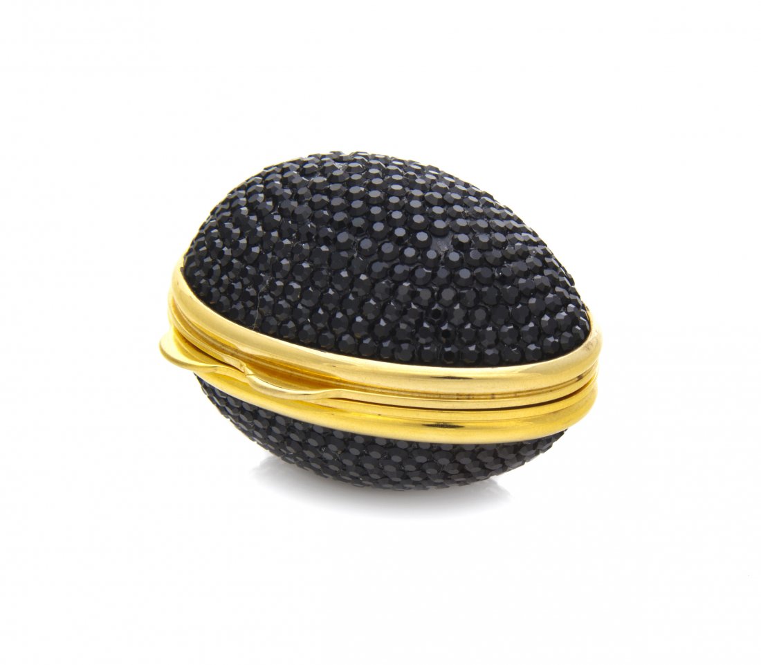 A Judith Leiber Black Crystal Egg Pillbox,: A Judith Leiber Black Crystal Egg Pillbox, cream enamel interior. Stamped: Judith Leiber.