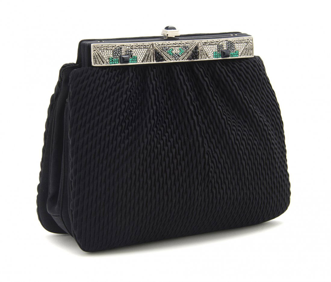 A Judith Leiber Black Satin Evening Clutch, 9 x 7: A Judith Leiber Black Satin Evening Clutch, in a pleated satin design with black, white and green Art Deco design closure and hidden silvertone chainlink shoulder strap. Stamp: Judith Leiber. 9 x 7 x