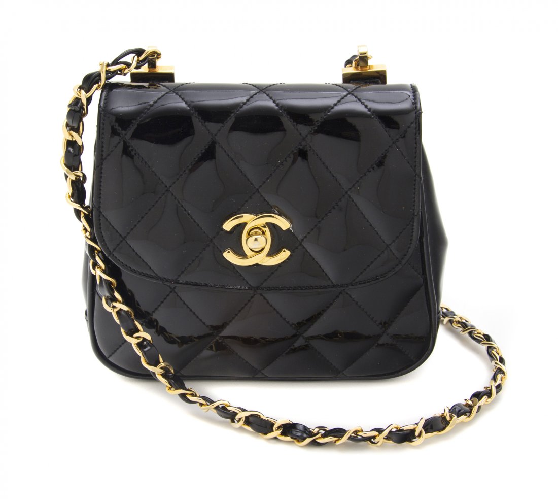 A Chanel Black Quilted Patent Leather Bag, 6 1/2 x: A Chanel Black Quilted Patent Leather Bag, goldtone logo closure and chainlink shoulder strap. Stamped: Chanel. 6 1/2 x 6 x 2 inches. Property from an Important Collector