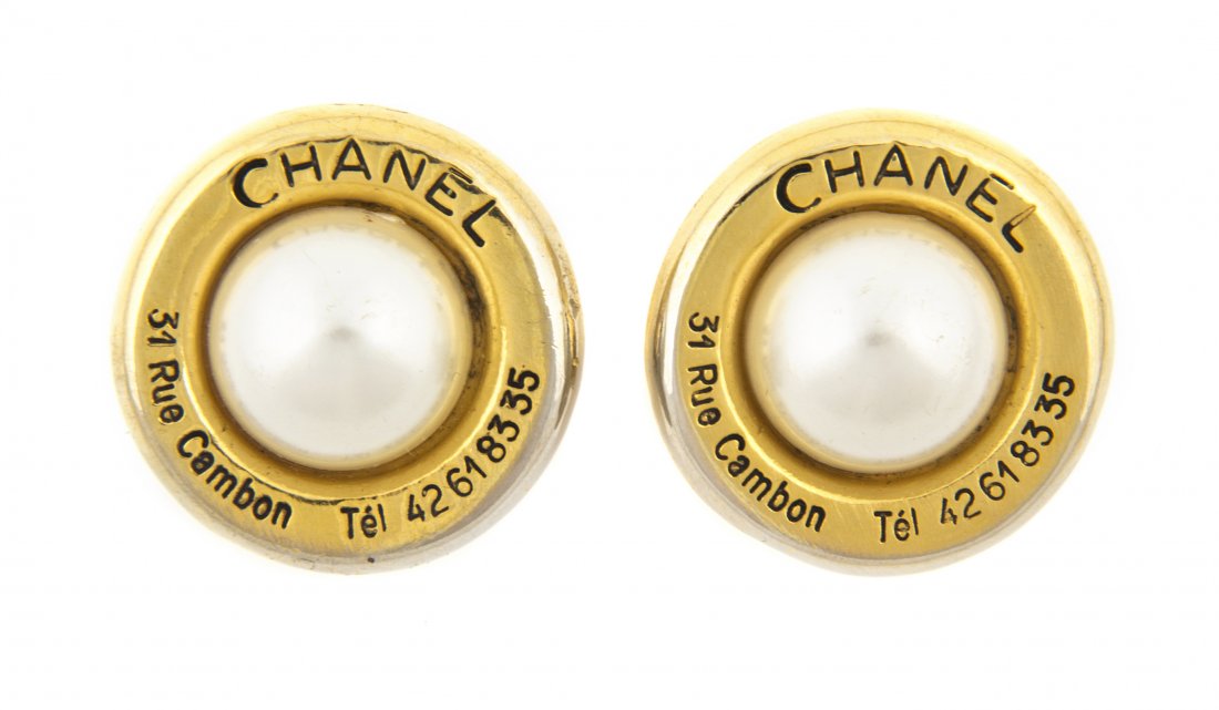 A Pair of Chanel Goldtone and Faux Pearl Earclips,: A Pair of Chanel Goldtone and Faux Pearl Earclips, probably Robert Goossens for Chanel, with "CHANEL 31 Rue Cambon Tel 42618355" inscribed around a large mabe pearl. Stamped: Chanel.