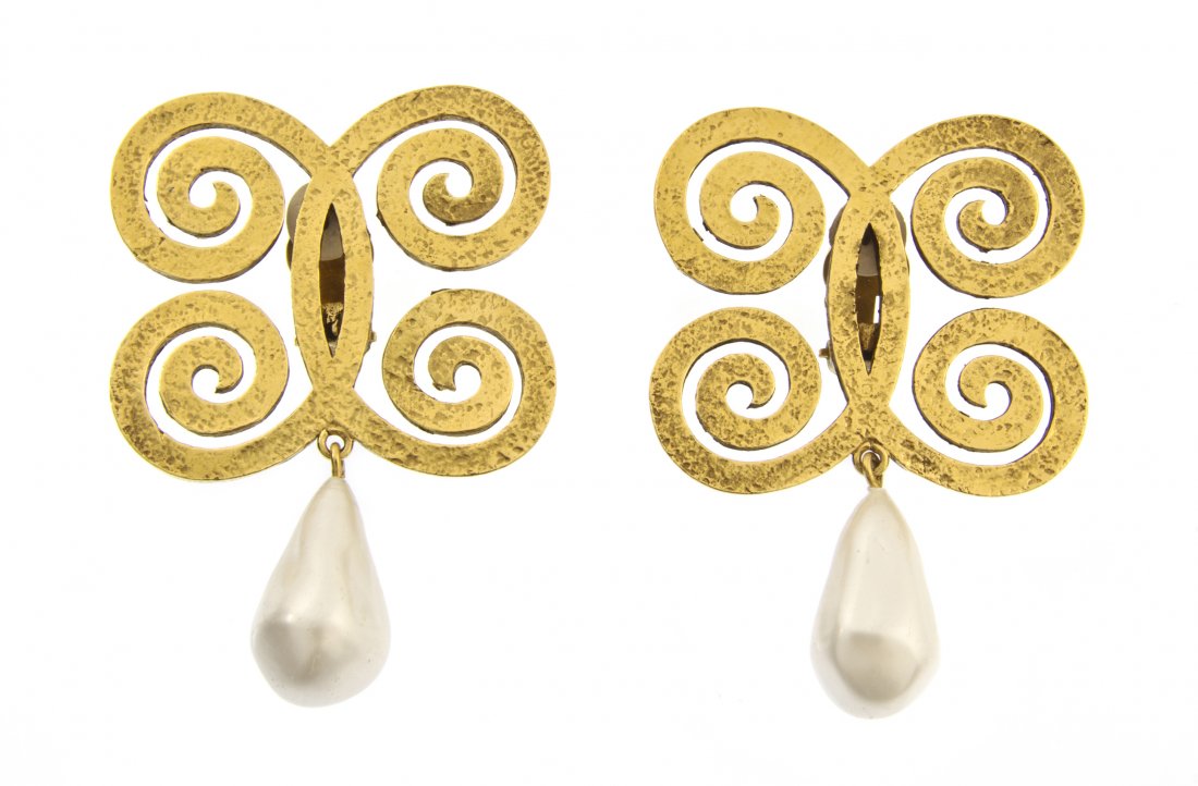 A Pair of Chanel Goldtone and Faux Pearl Barbaric: A Pair of Chanel Goldtone and Faux Pearl Barbaric Style Earclips, probably Robert Goossens for Chanel, in an interlocking scroll design, with large pearl drops. Stamped: Chanel.
