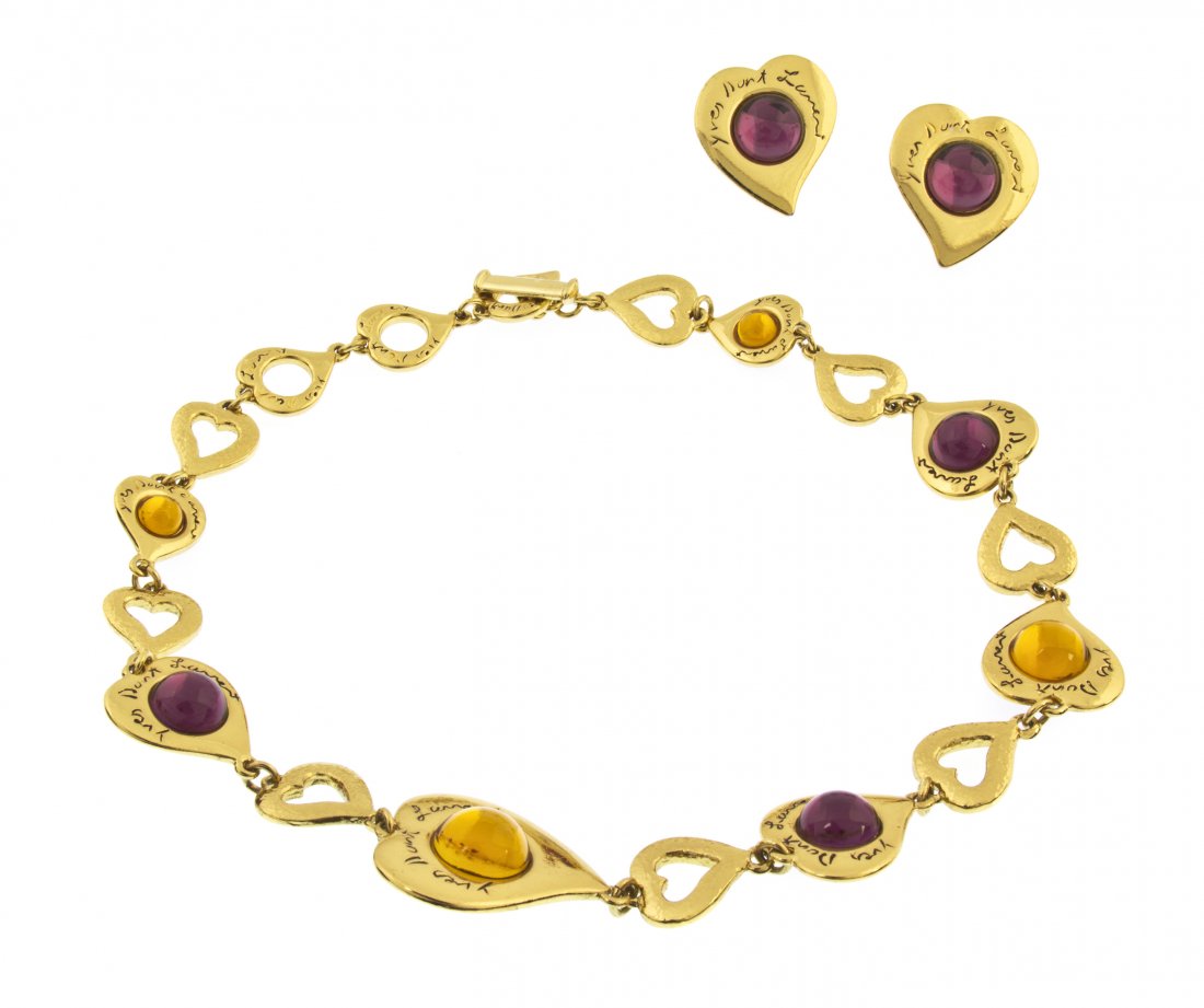 An Yves Saint Laurent Multicolor Cabochon and Gold: An Yves Saint Laurent Multicolor Cabochon and Goldtone Suite, consisting of a pair of earclips and a necklace, with purple and yellow cabochons and 'Yves Saint Laurent' engraved on the larger heart sh