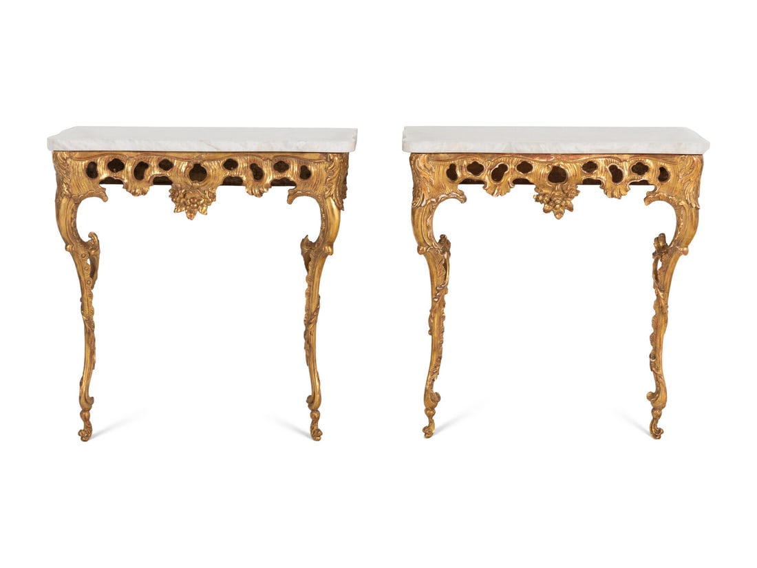 A Pair of North European Rococo Giltwood Marble-Top Console Tables: A Pair of North European Rococo Giltwood Marble-Top Console Tables Mid-18th Century the tops replaced. Height 32 x width 31 1/2 x depth 18 inches. This lot is located in Chicago.