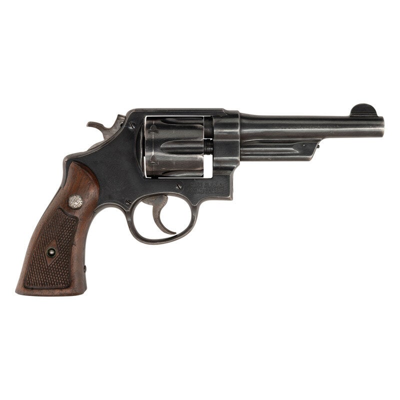 **Smith & Wesson Pre-Model 20 38/44: **Smith & Wesson Pre-Model 20 38/44 .38 Special. 5" barrel length. SN: S105479. Blued metal finish with jeweled hammer, color case hardened trigger, and mounting checkered walnut Smith & Wesso