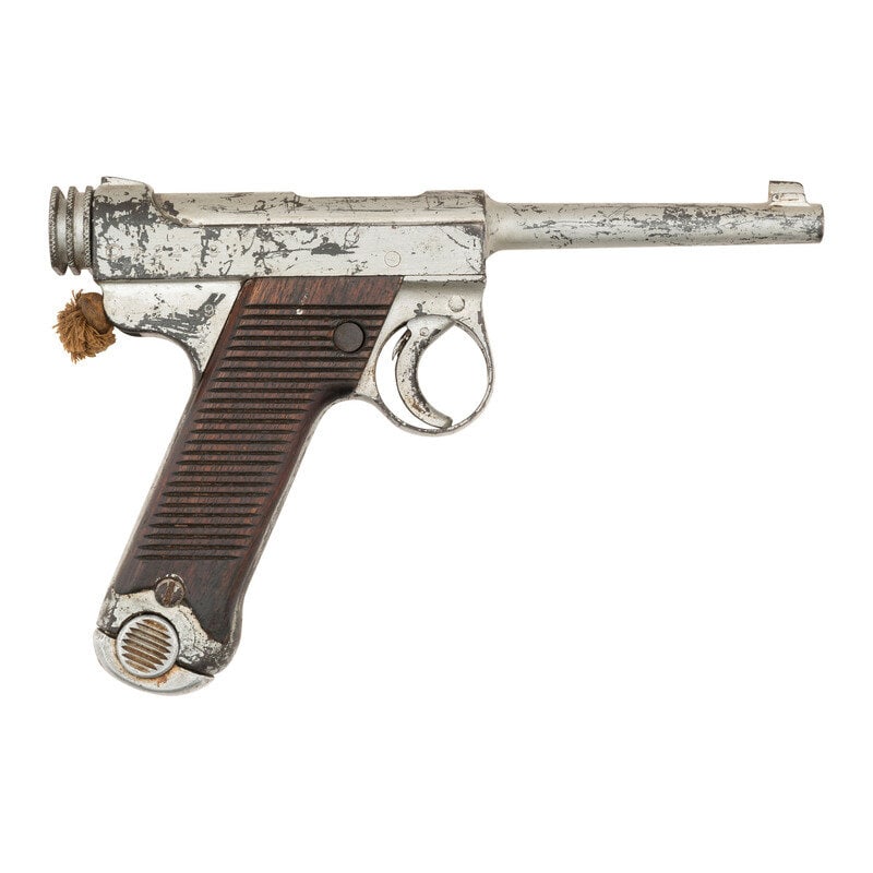 **Japanese Nambu Type 14: **Japanese Nambu Type 14 8x22mm Nambu. 4.61" barrel length. SN: 22294. Silver painted refinish overall with red painted left and unpainted right grips mounting standard rear notch and front blade sigh