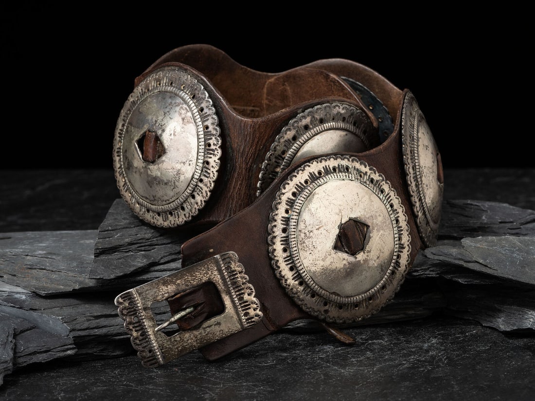 Navajo First Phase Concha Belt, Collected by Hoffman Birney (1891-1958): Navajo First Phase Concha Belt, Collected by Hoffman Birney (1891-1958) fourth quarter 19th century seven round conchas, each with scalloped edge and heavily chiseled design; matching rectangular buck